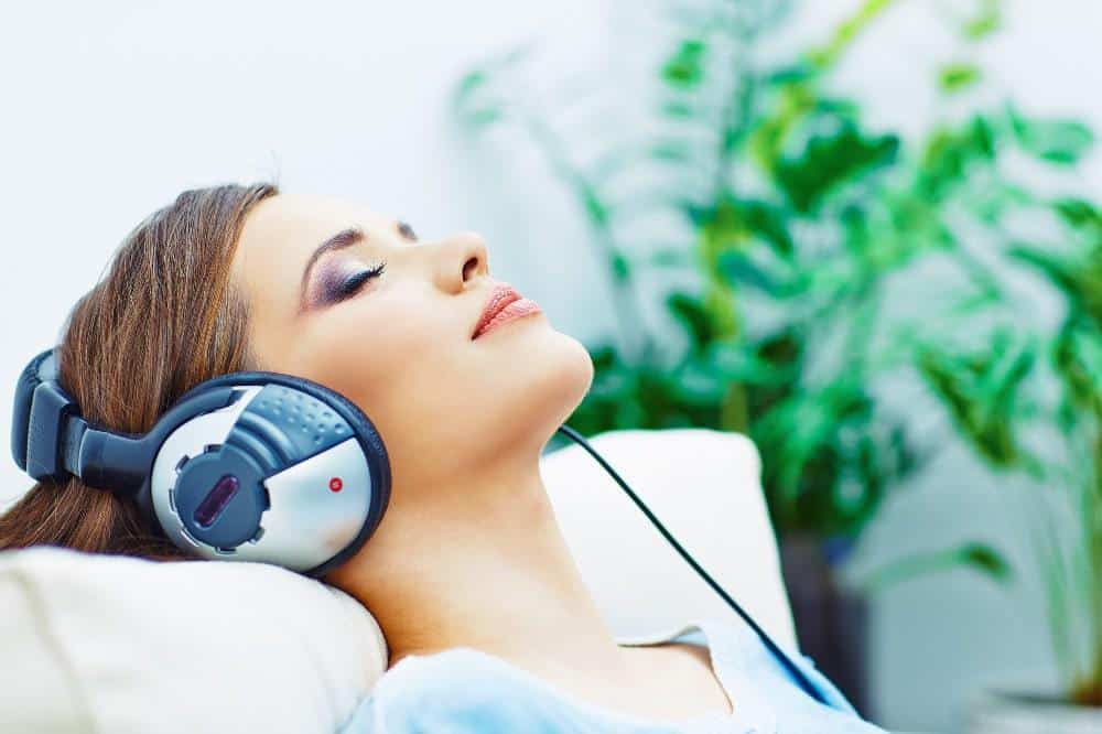 a woman listening to binaural beats for anxiety