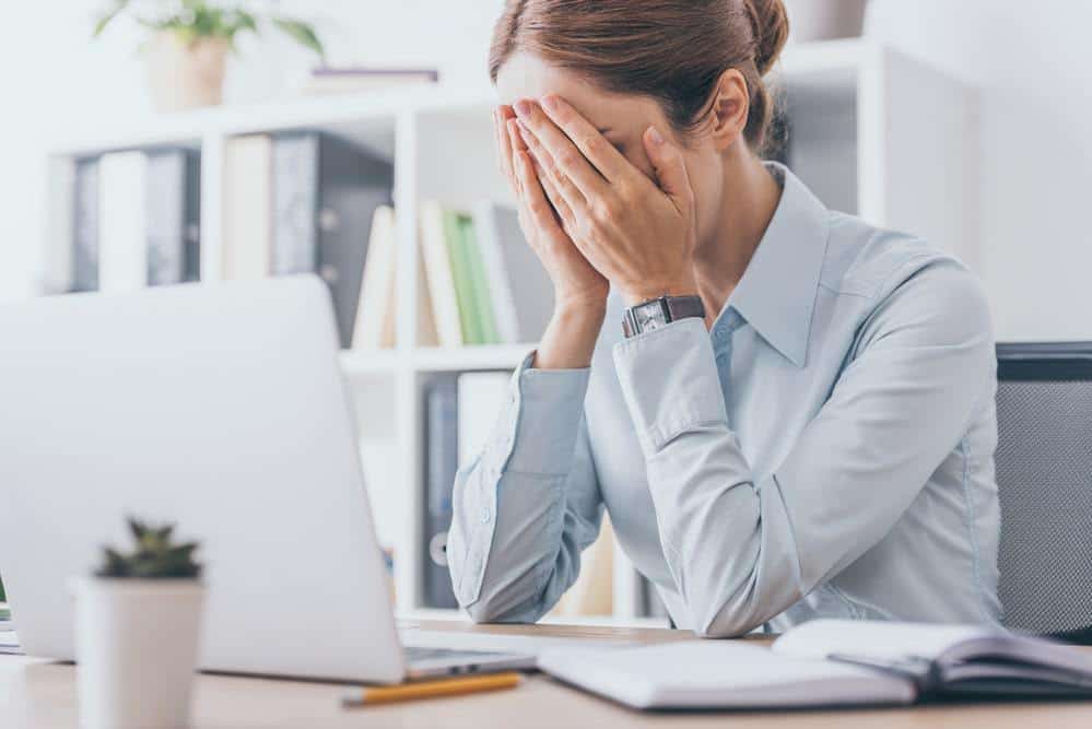 stressed woman in the office and why stress poses a threat to quality of life